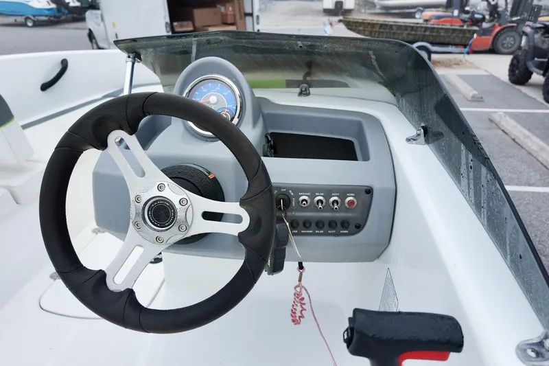 Slide: The Image of Steering console of a 2021 Tahoe T16 boat with controls and dashboard. - 8