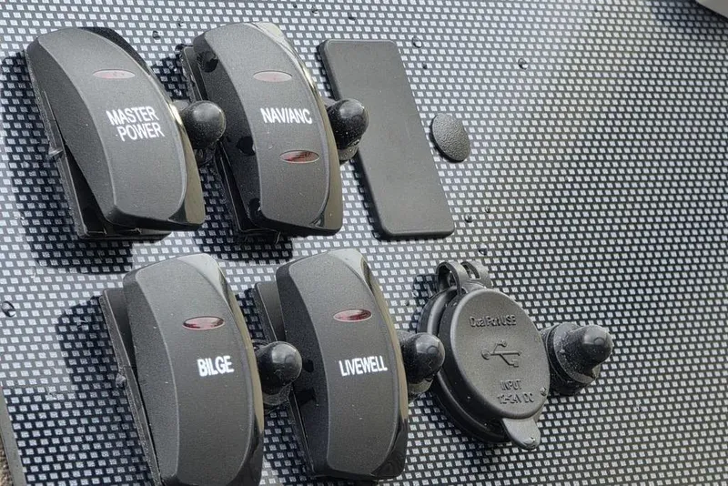 Slide: The Image of Control panel of 2026 Xpress H20B Bay boat with labeled switches and USB port. - 18