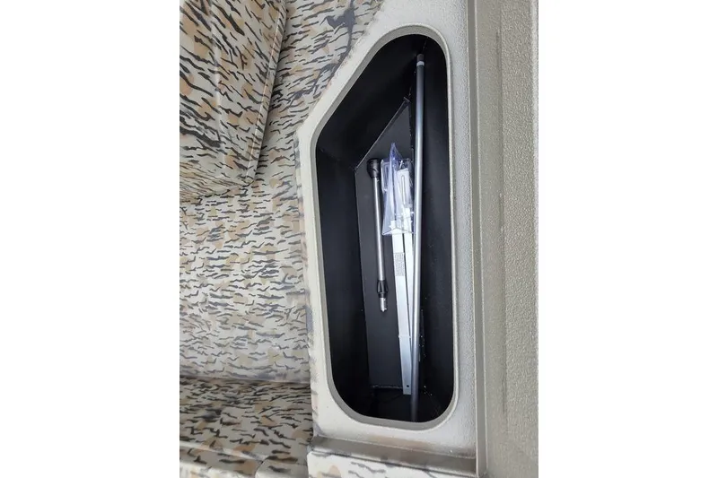 Slide: The Image of 2026 Xpress H20B Bay boat storage compartment with camouflage interior design. - 20