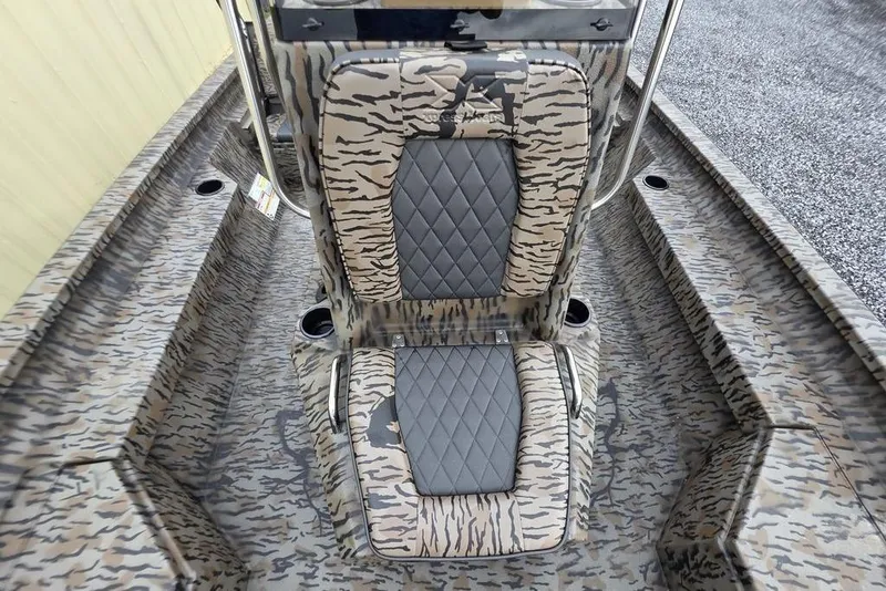 Slide: The Image of 2026 Xpress H20B Bay boat interior with camo pattern and cushioned seating. - 21