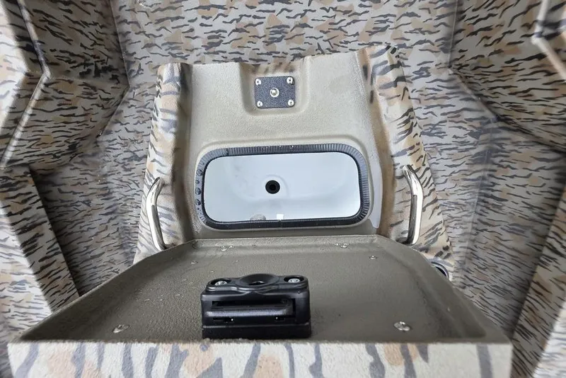 Slide: The Image of Interior of 2026 Xpress H20B Bay boat with camouflage design and storage compartment. - 24