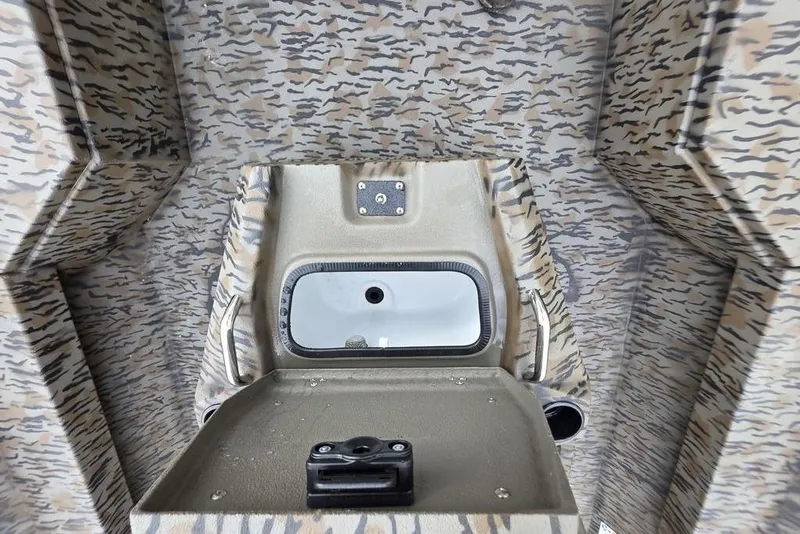 Slide: The Image of 2026 Xpress H20B Bay boat interior with camouflage pattern and storage compartment. - 26