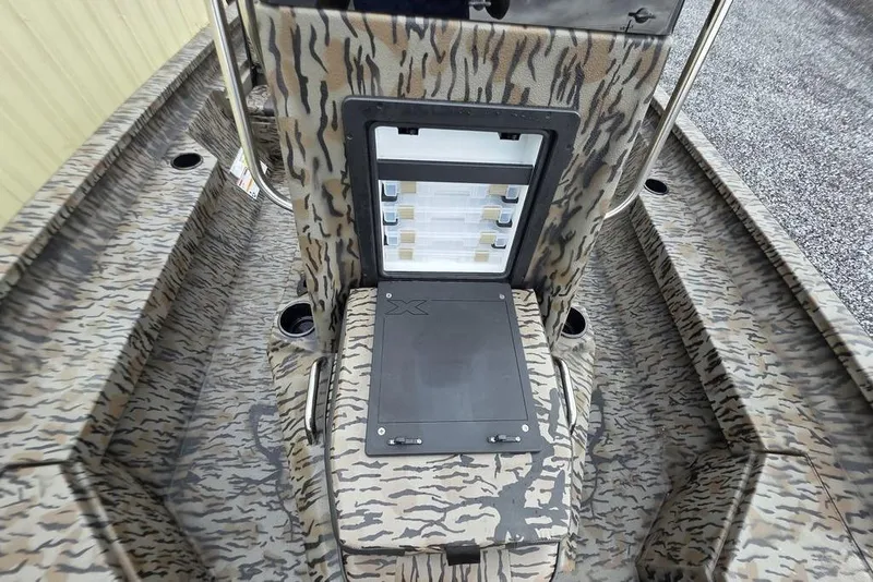 Slide: The Image of 2026 Xpress H20B Bay boat interior with camouflage design and storage compartment. - 27