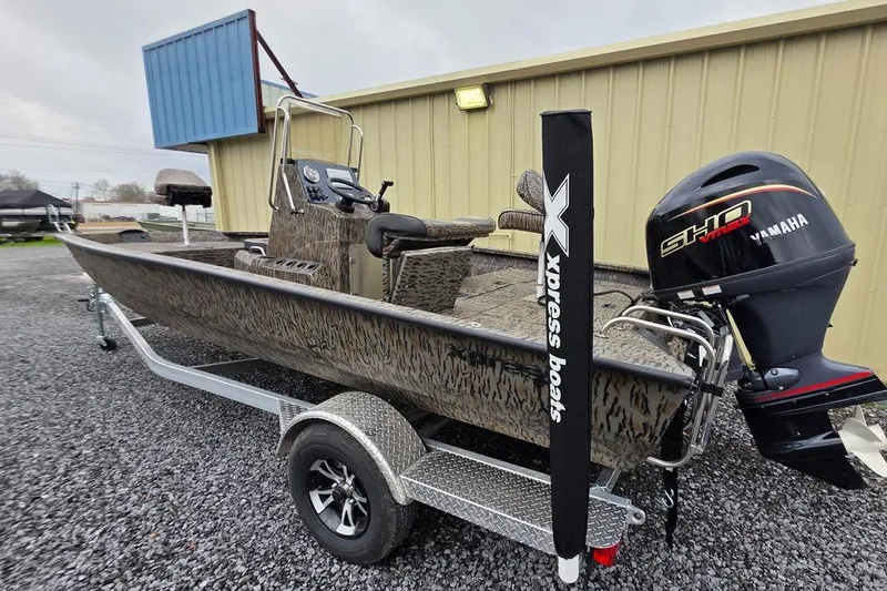 Slide: The Image of 2026 Xpress H20B Bay boat with Yamaha engine on trailer, parked outdoors. - 8