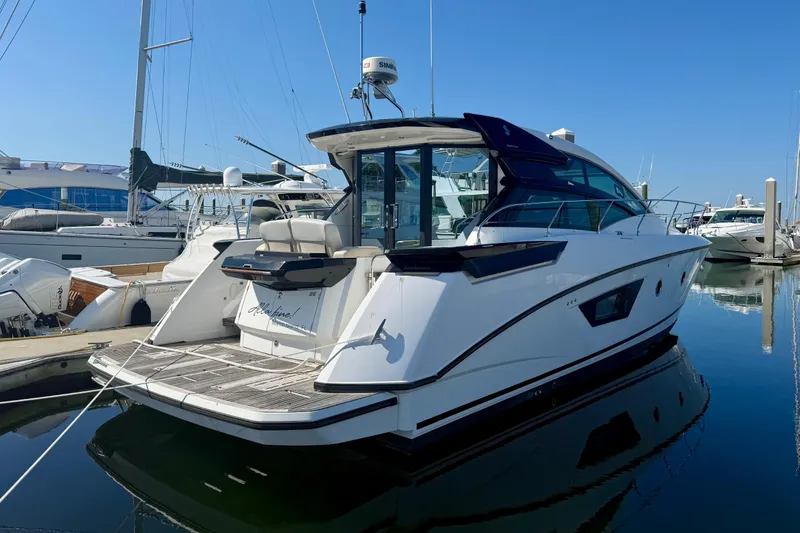The Image of 2019 Beneteau Gran Turismo 46 yacht docked in a marina under clear blue skies. - 0