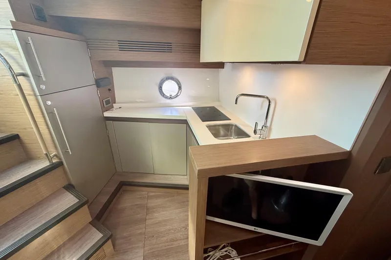 Slide: The Image of 2019 Beneteau Gran Turismo 46 yacht interior kitchen with modern appliances and sleek design. - 10