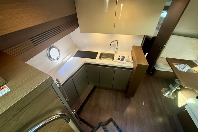 Slide: The Image of Luxurious interior of 2019 Beneteau Gran Turismo 46 yacht, featuring modern kitchen and dining area. - 11