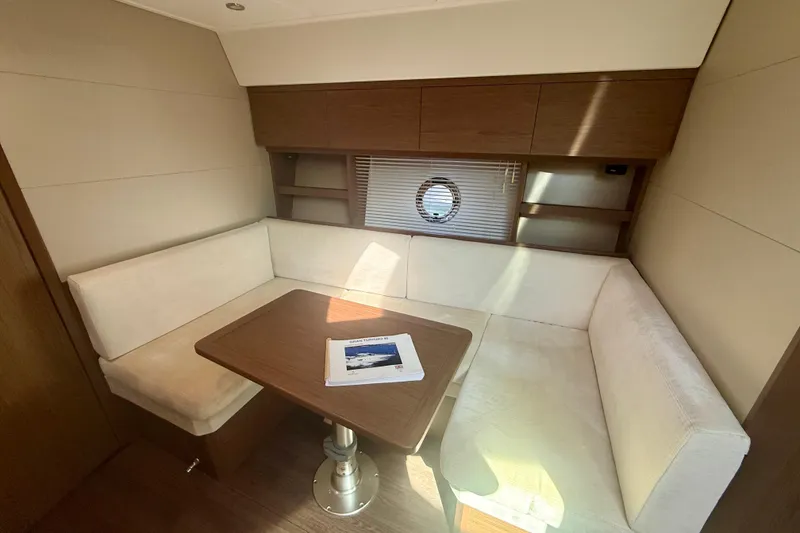 Slide: The Image of Interior of 2019 Beneteau Gran Turismo 46 yacht with cozy seating and table. - 12