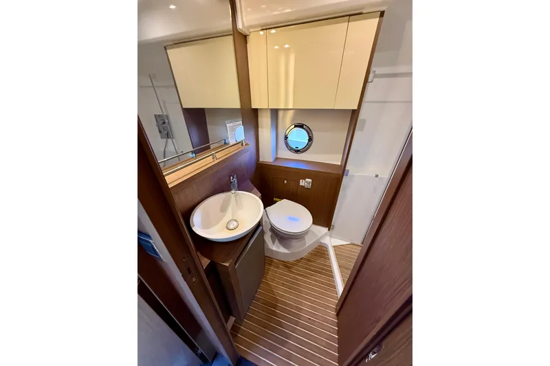 Slide: The Image of Luxurious bathroom in 2019 Beneteau Gran Turismo 46 yacht with modern fixtures and wood accents. - 13