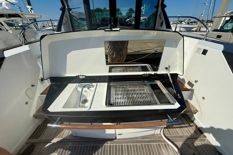 Slide: The Image of Outdoor kitchen on a 2019 Beneteau Gran Turismo 46 yacht, featuring a grill and sink. - 14