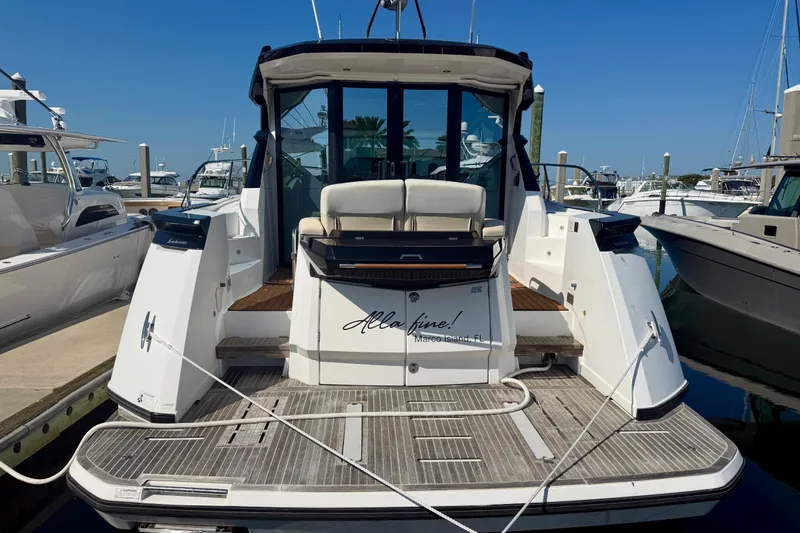 Slide: The Image of 2019 Beneteau Gran Turismo 46 yacht docked at marina, rear view. - 2