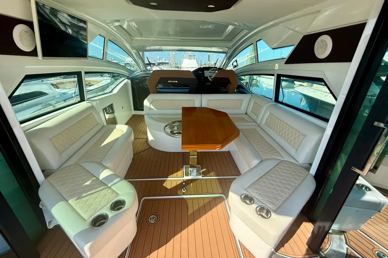 Slide: The Image of Luxurious interior of 2019 Beneteau Gran Turismo 46 yacht with elegant seating and wooden table. - 3