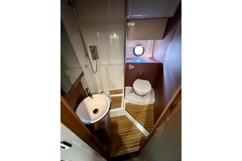 Slide: The Image of 2019 Beneteau Gran Turismo 46 yacht bathroom with shower, sink, and toilet. - 32