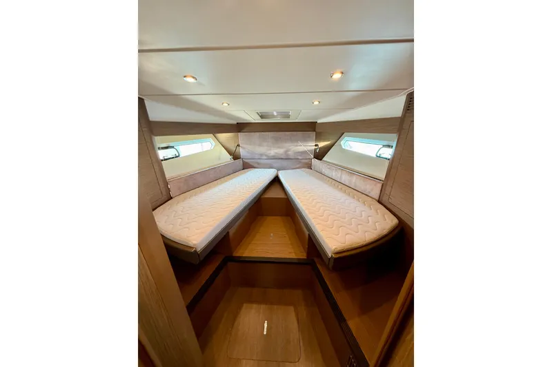 Slide: The Image of 2019 Beneteau Gran Turismo 46 cabin interior with twin beds and modern lighting. - 34