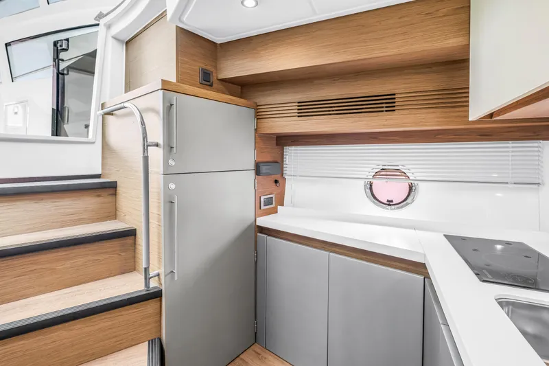 Slide: The Image of Modern kitchen interior of 2019 Beneteau Gran Turismo 46 yacht, featuring sleek cabinetry and appliances. - 39
