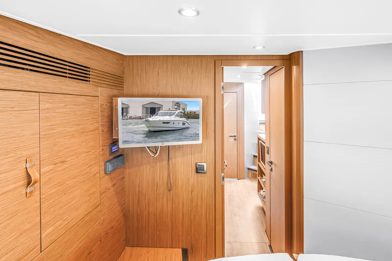 Slide: The Image of Interior of 2019 Beneteau Gran Turismo 46 yacht with wooden paneling and mounted TV. - 47