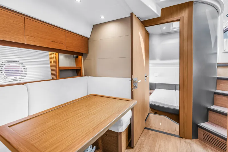 Slide: The Image of Luxurious interior of 2019 Beneteau Gran Turismo 46 yacht with wooden finishes and cozy seating. - 51