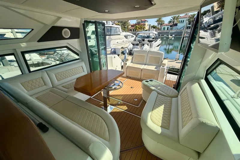 Slide: The Image of Luxurious interior of 2019 Beneteau Gran Turismo 46 yacht with elegant seating and wooden table. - 6