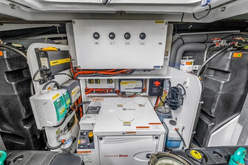Slide: The Image of Engine room of 2019 Beneteau Gran Turismo 46 with Cummins Onan generator and electrical systems. - 61