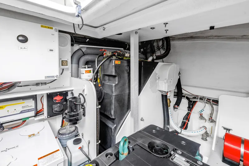 Slide: The Image of Engine room of 2019 Beneteau Gran Turismo 46 yacht, showcasing mechanical components and wiring. - 62
