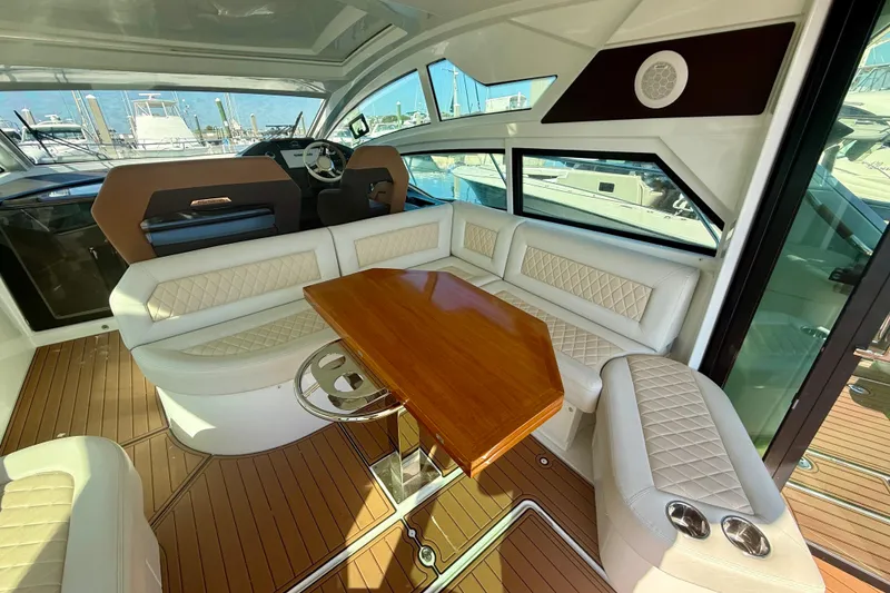 Slide: The Image of Luxurious interior of 2019 Beneteau Gran Turismo 46 yacht with elegant seating and wooden table. - 7