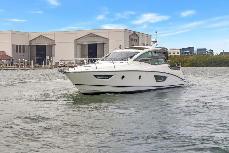Slide: The Image of 2019 Beneteau Gran Turismo 46 yacht cruising near industrial buildings. - 78