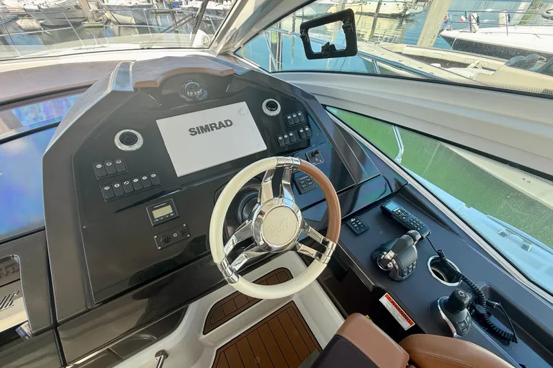 Slide: The Image of 2019 Beneteau Gran Turismo 46 helm with Simrad display and modern controls. - 8