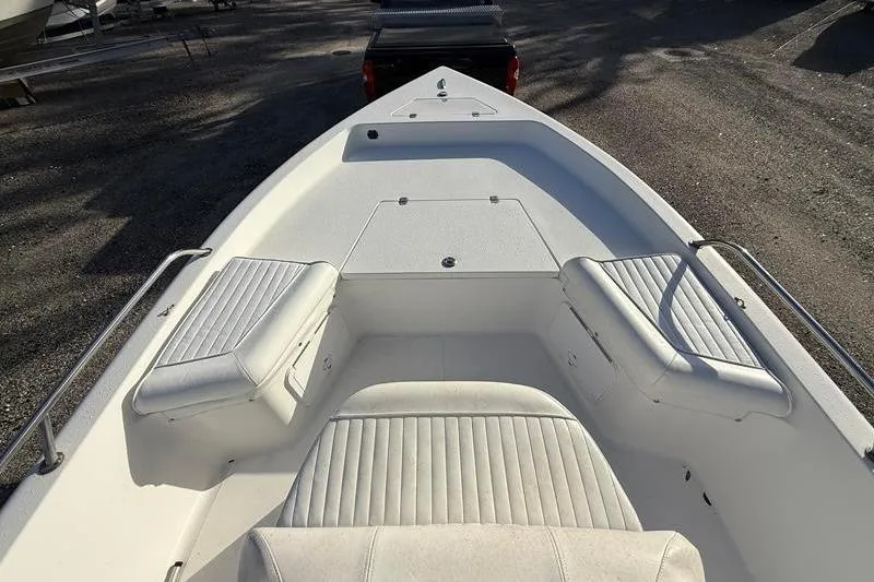 Slide: The Image of 2007 Sea Pro SV1900CC Bay Boat interior with white seating and storage compartments. - 18