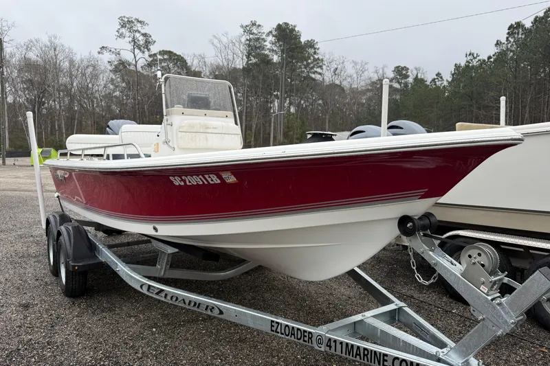 Slide: The Image of 2007 Sea Pro SV1900CC Bay Boat on trailer, red and white, parked outdoors. - 7