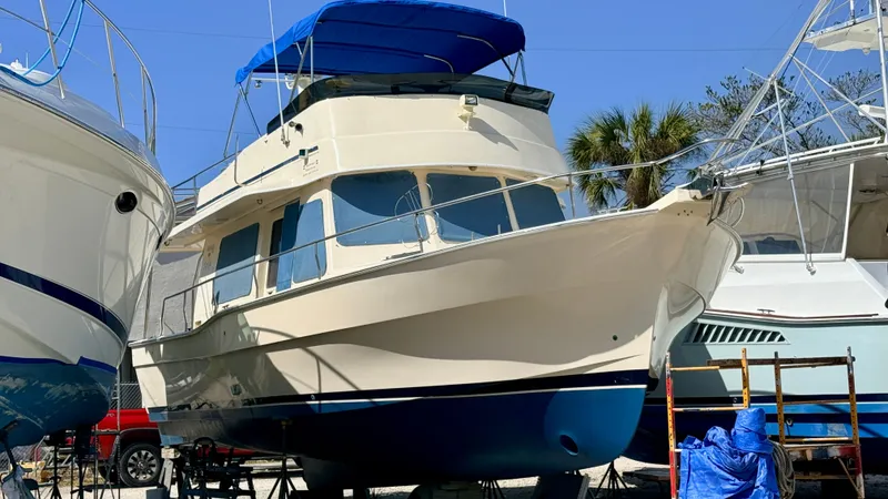 Slide: The Image of 2004 Mainship 400 Trawler in dry dock, blue sky. - 0