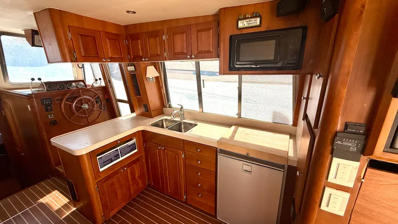 Slide: The Image of Interior of 2004 Mainship 400 Trawler with kitchen and helm area. - 14