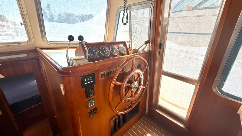 Slide: The Image of 2004 Mainship 400 Trawler helm with wooden finish. - 19