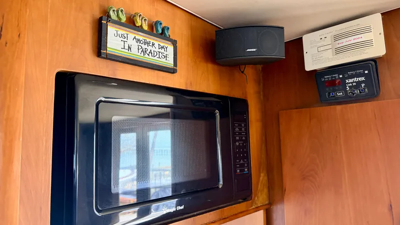 Slide: The Image of Microwave and decor inside a 2004 Mainship 400 Trawler. - 26