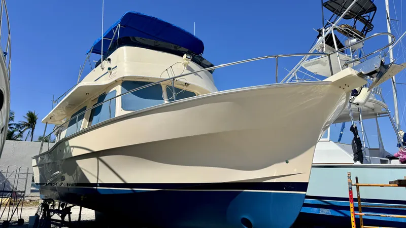 Slide: The Image of 2004 Mainship 400 Trawler on dry dock under clear blue sky. - 4