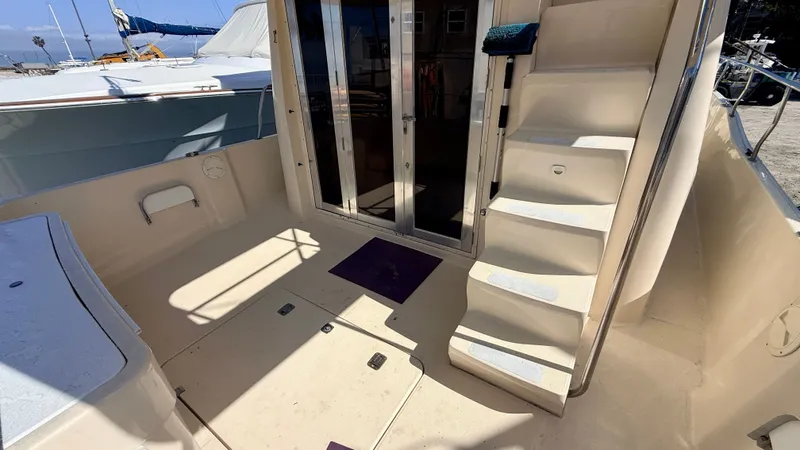 Slide: The Image of 2004 Mainship 400 Trawler, boat deck with stairs and glass doors. - 7