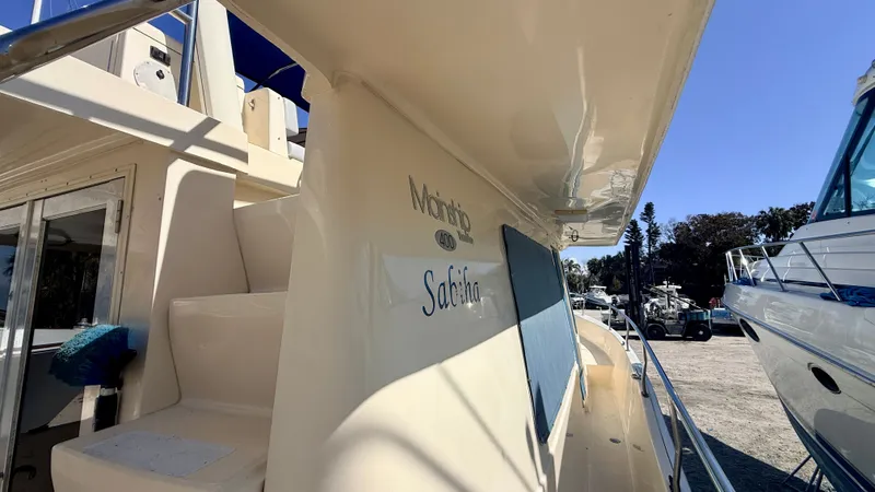 Slide: The Image of 2004 Mainship 400 Trawler docked, side view. - 8