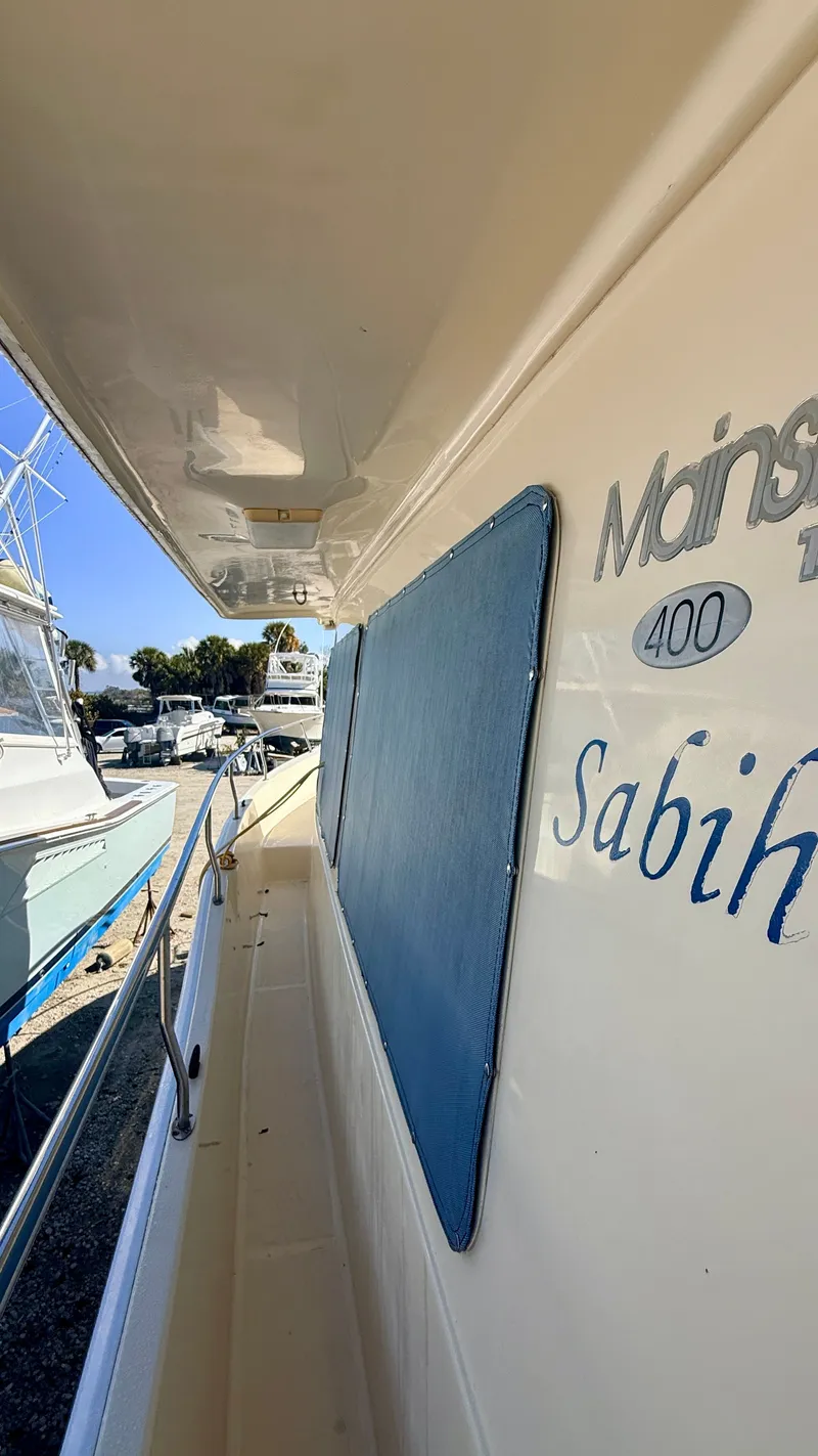 Slide: The Image of 2004 Mainship 400 Trawler side view in harbor. - 9