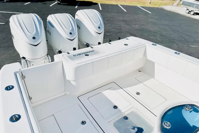 Slide: The Image of 2025 Contender 35 ST boat with triple Yamaha outboard engines, spacious deck view. - 16
