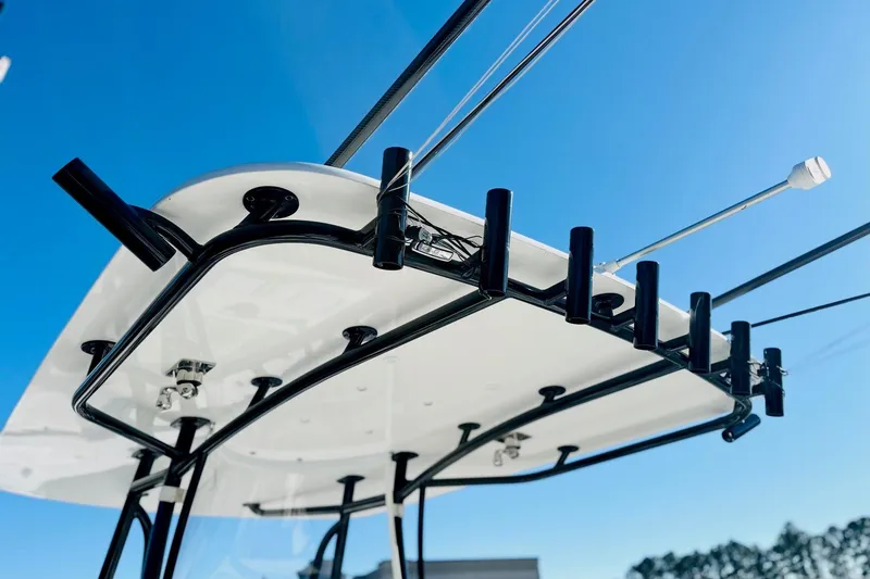 Slide: The Image of 2025 Contender 35 ST boat with Garmin equipment, parked outdoors with trees in the background. - 8