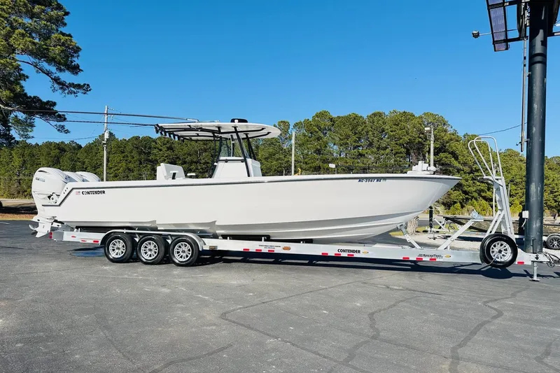 Slide: The Image of 2025 Contender 35 ST boat's T-top with rod holders against clear blue sky. - 9