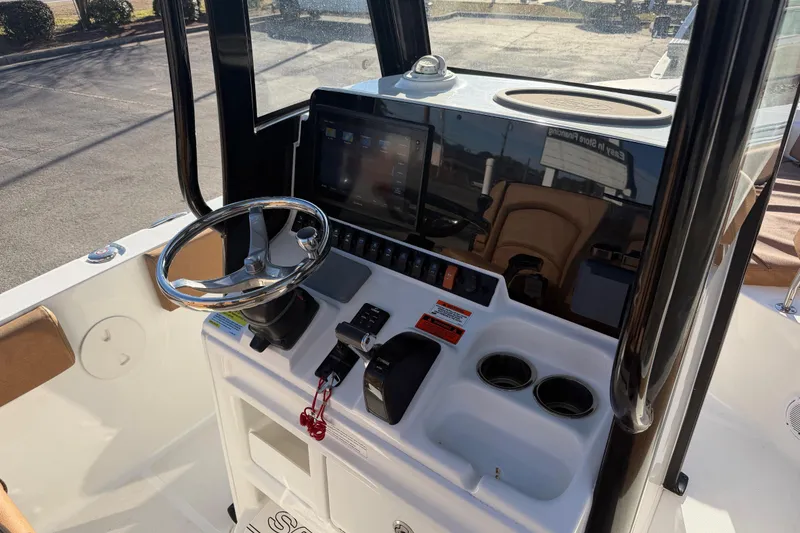 Slide: The Image of 2020 Sea Hunt Ultra 235 SE boat interior with cushioned seating and storage compartments. - 10