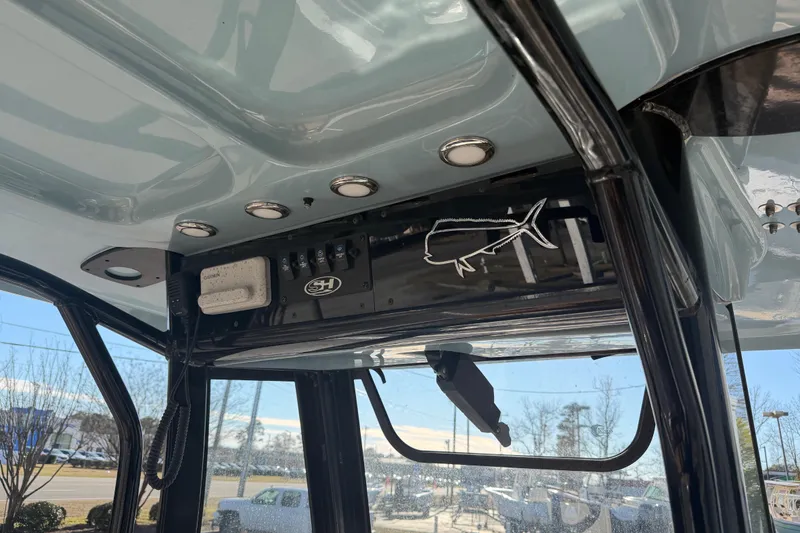 Slide: The Image of 2020 Sea Hunt Ultra 235 SE boat interior with open storage compartments. - 11