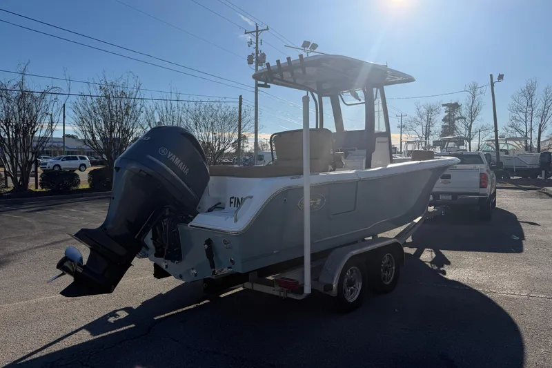 Slide: The Image of 2020 Sea Hunt Ultra 235 SE boat on water near dockside homes. - 3