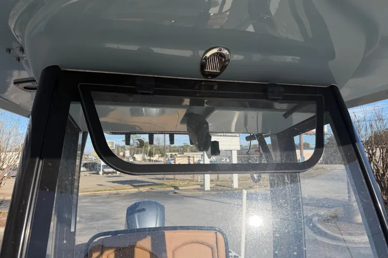 Slide: The Image of 2020 Sea Hunt Ultra 235 SE boat cruising on a calm waterway near a dock. - 6