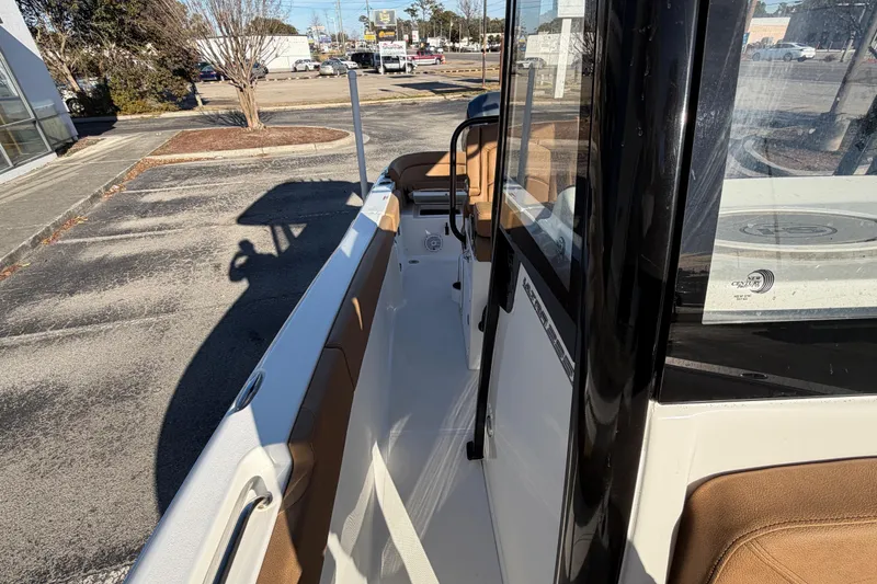 Slide: The Image of 2020 Sea Hunt Ultra 235 SE boat with tan seating, on calm water. - 8