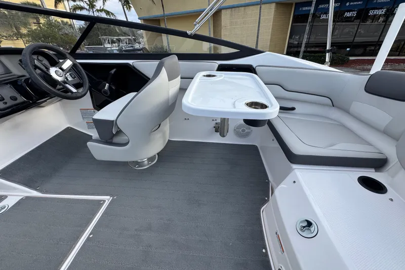 Slide: The Image of 2025 Yamaha Boats SX190 interior with steering wheel, seating, and table setup. - 11