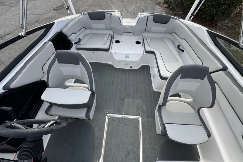 Slide: The Image of 2025 Yamaha Boats SX190 interior with modern seating and steering wheel. - 7