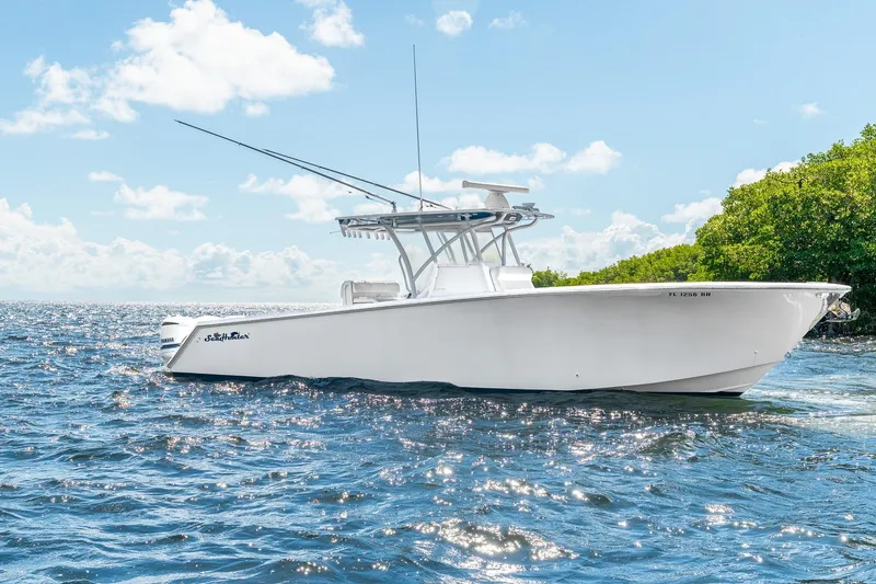 The Image of 2017 SeaHunter 35 Tournament boat on open water, clear sky, lush greenery. - 1