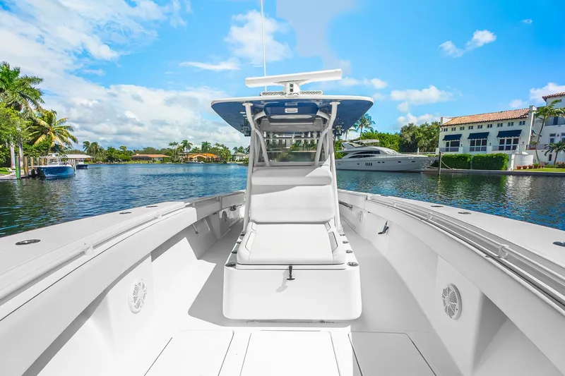 Slide: The Image of 2017 SeaHunter 35 Tournament boat on a sunny waterfront, showcasing spacious deck and sleek design. - 5