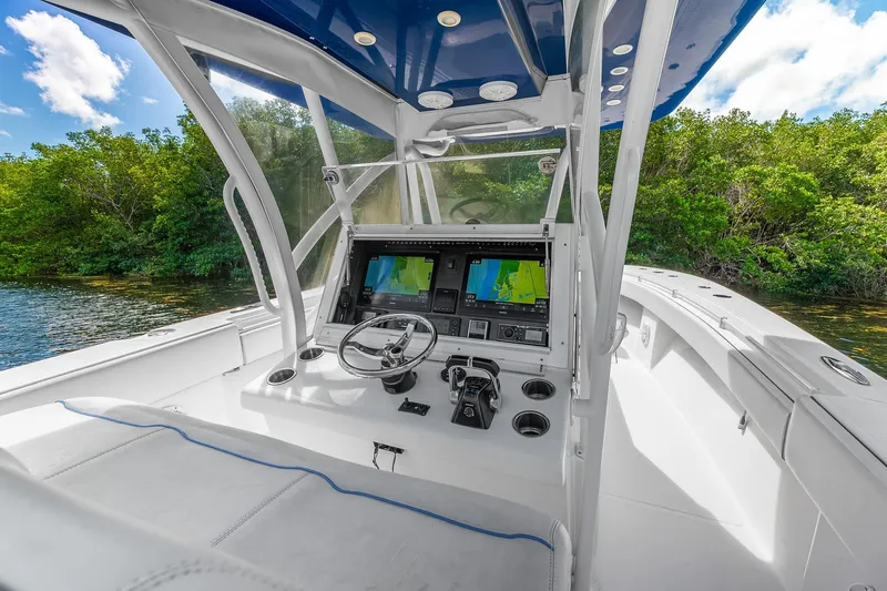 Slide: The Image of 2017 SeaHunter 35 Tournament boat cockpit with navigation screens and steering wheel. - 6